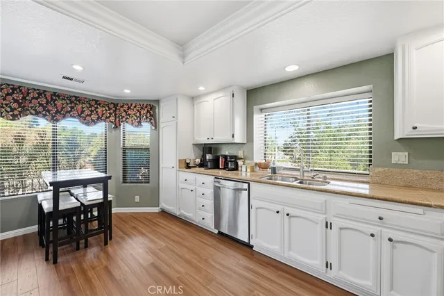 a kitchen with granite countertop white cabinets and white appliances
