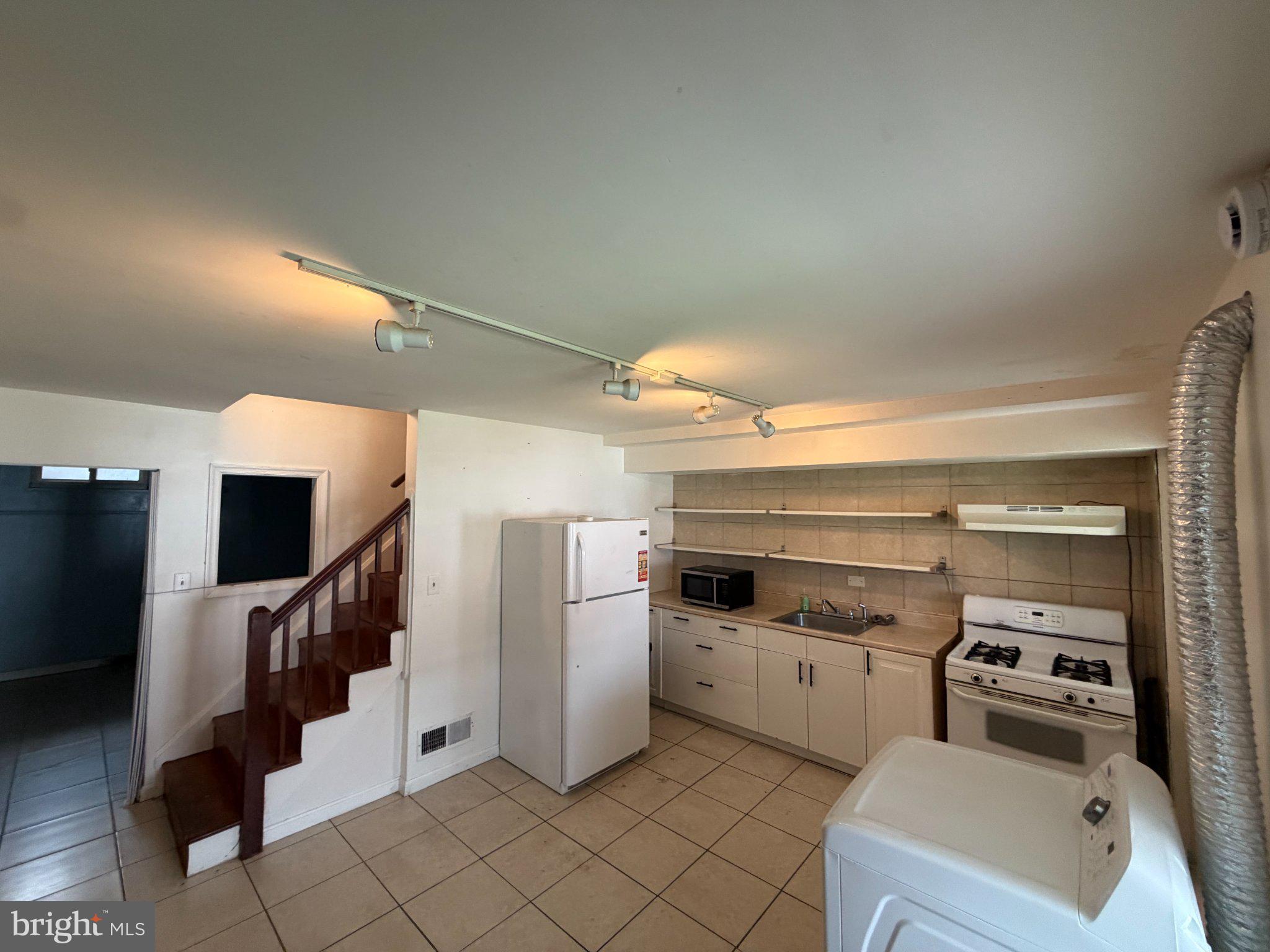 7216 Conley Street Baltimore, MD 21224 - Photo 13 of 14 Modern kitchen with open layout charm.