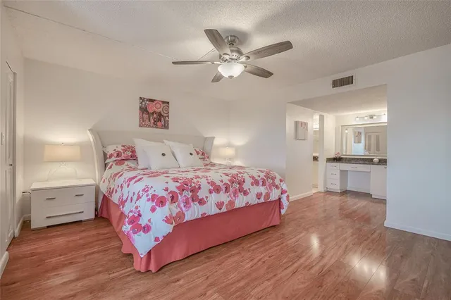 a bathroom with a granite countertop sink and a toilet