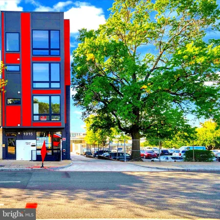 a open kitchen with stainless steel appliances granite countertop a stove top oven a sink dishwasher and white cabinets with wooden floor