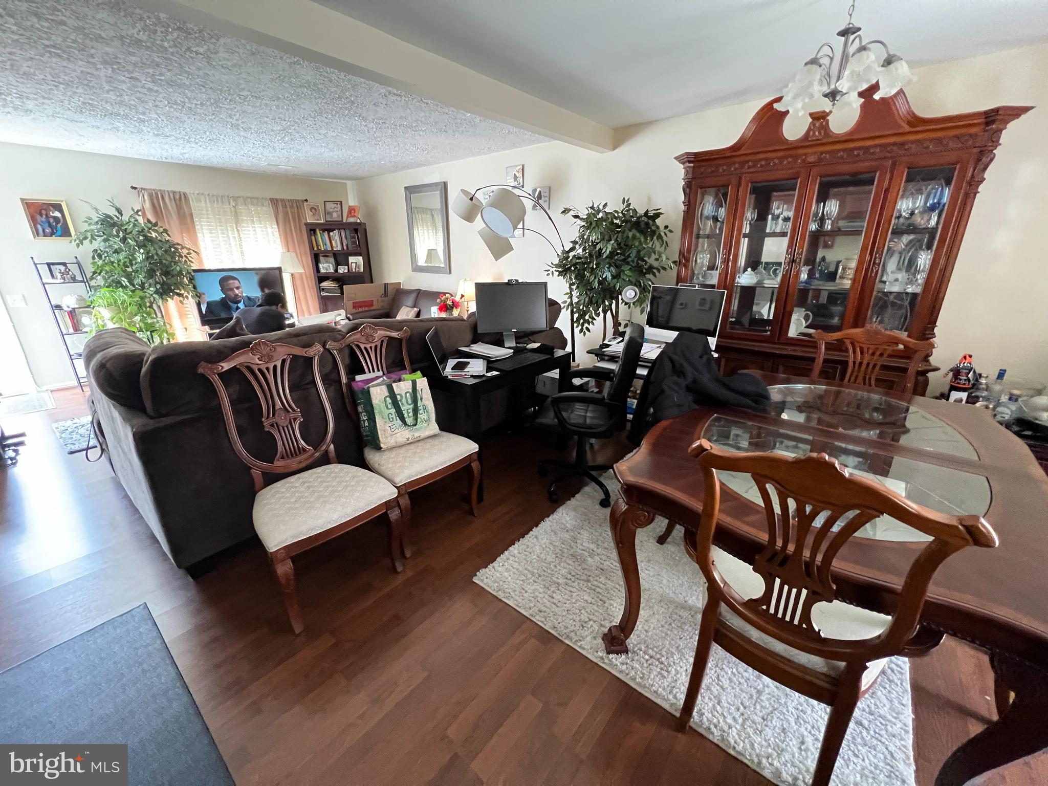 1915 Benning Road Northeast, Unit 8 Washington, DC 20002 - Photo 17 of 18 a living room with furniture and a chandelier