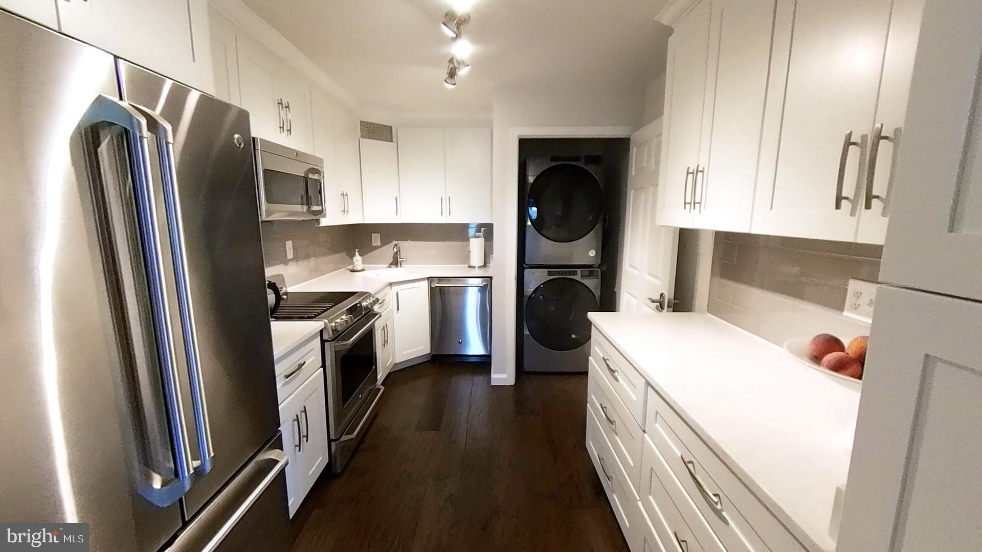 1915 Benning Road Northeast, Unit 8 Washington, DC 20002 - Photo 6 of 18 a kitchen with a refrigerator a washer and dryer