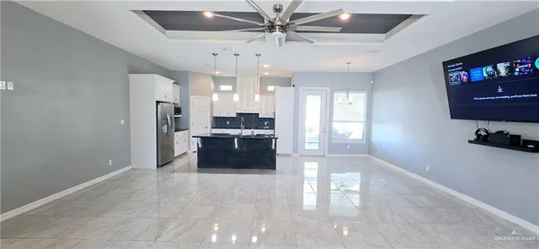 a large white kitchen with a large window cabinets and stainless steel appliances
