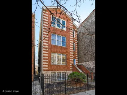 a view of a brick building next to a yard