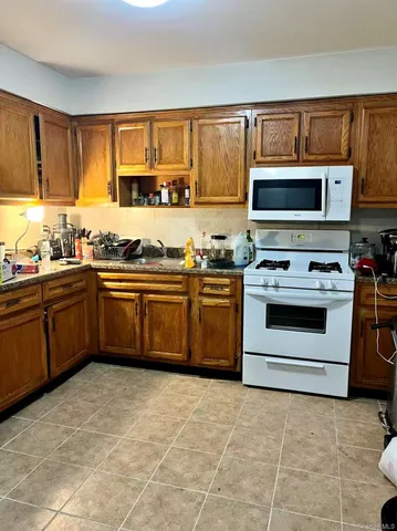 a kitchen with stainless steel appliances a stove sink and cabinets