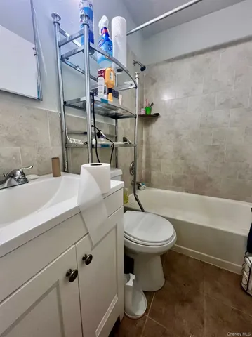 a bathroom with a sink a toilet and bathtub