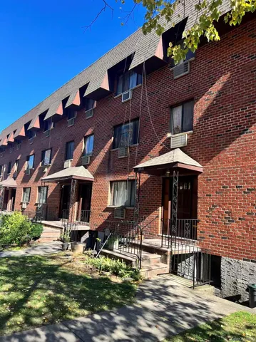 a front view of a building with swimming pool