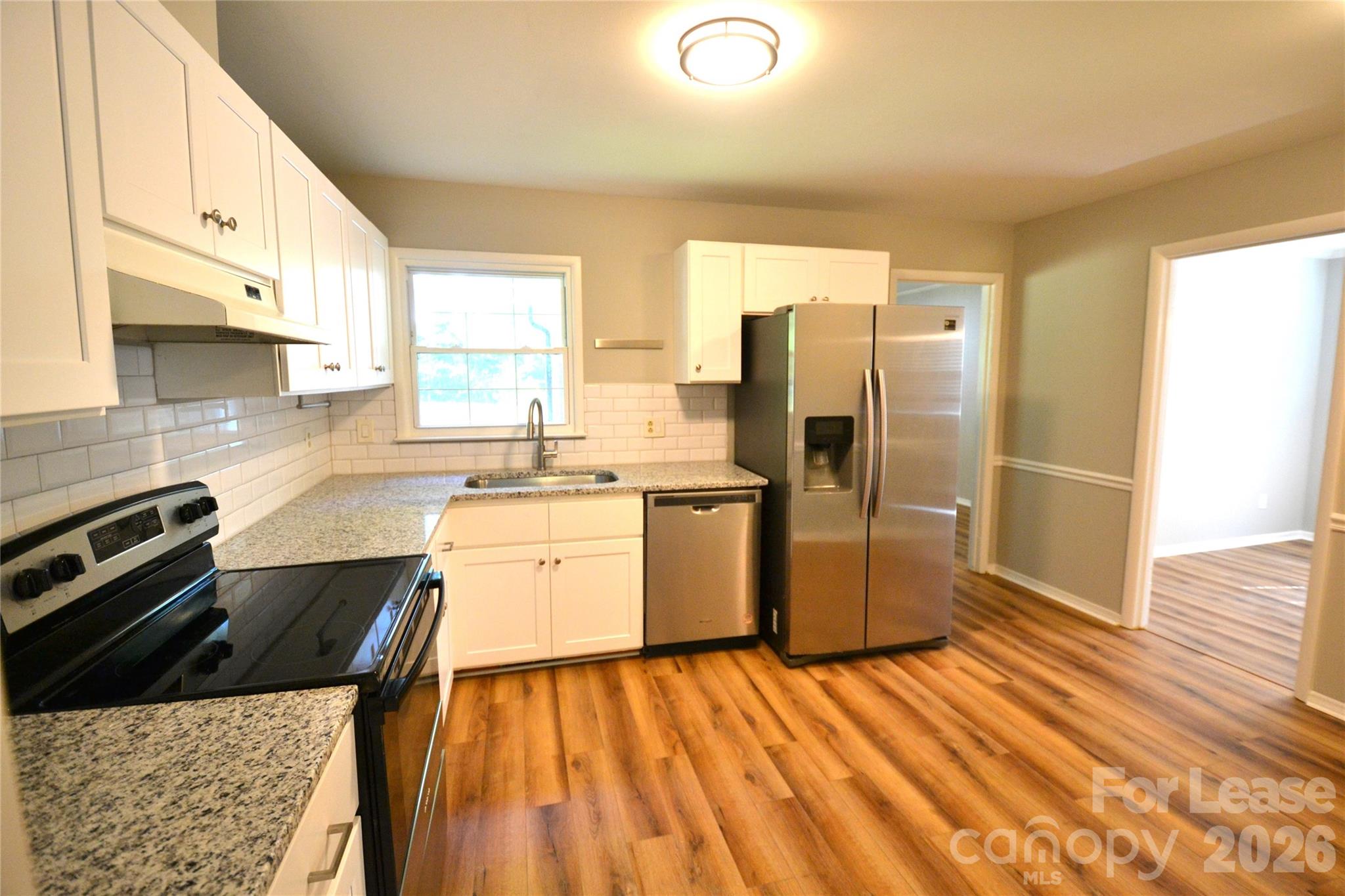 1422 Thermal Road Charlotte, NC 28212 - Photo 16 of 40 a kitchen with a sink a counter top space stainless steel appliances and cabinets