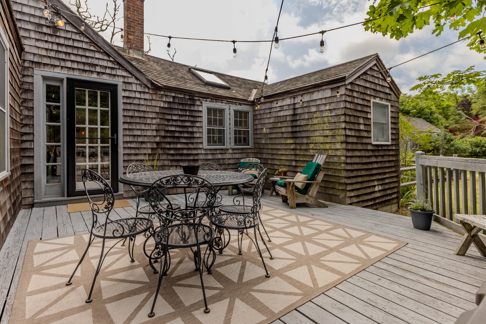 10 Danls Way West Tisbury, MA 02568 - Photo 21 of 41 a patio with table and chairs and potted plants