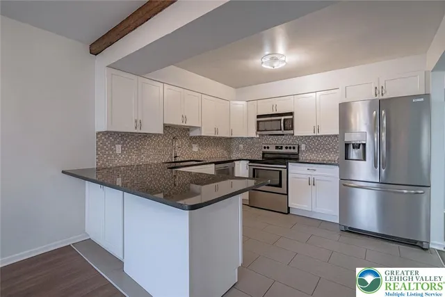 a kitchen with a refrigerator stove and microwave