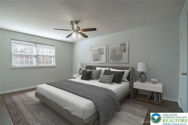 a bedroom with a bed ceiling fan and a window