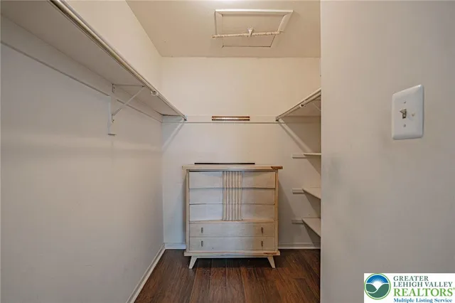a view of walk in closet with empty racks