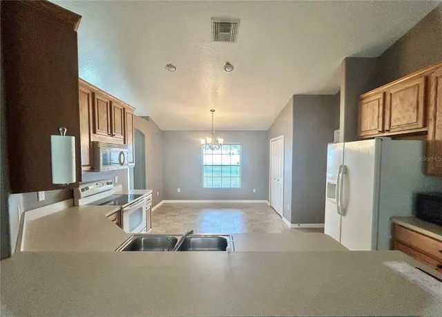 a view of a kitchen with a sink and dishwasher