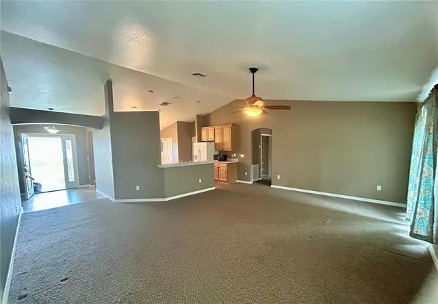 a view of an empty room and a window