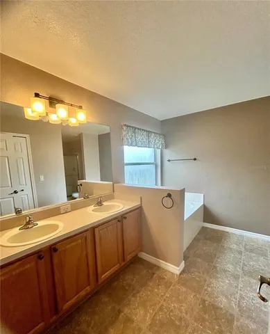 a view of a backyard with large trees