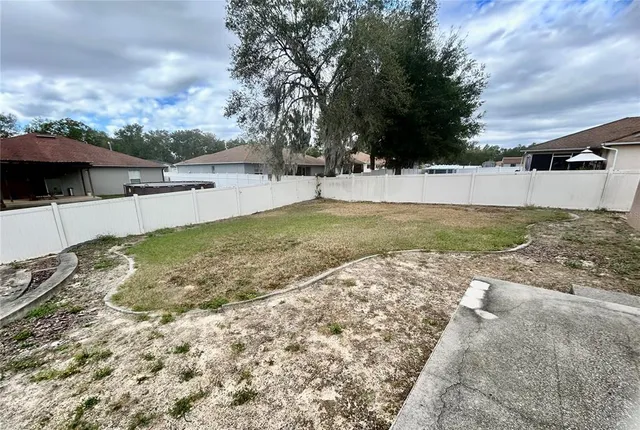 a view of backyard of house and car parked