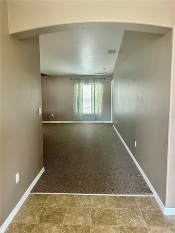 an empty room with floor to ceiling windows