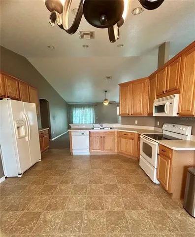 a kitchen with stainless steel appliances a stove sink and microwave