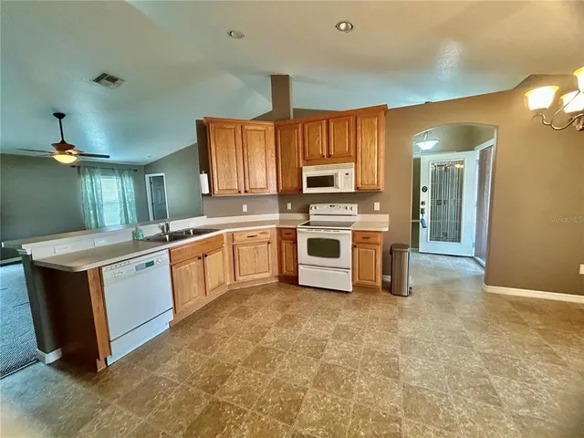 a large kitchen with a lot of cabinets and stainless steel appliances