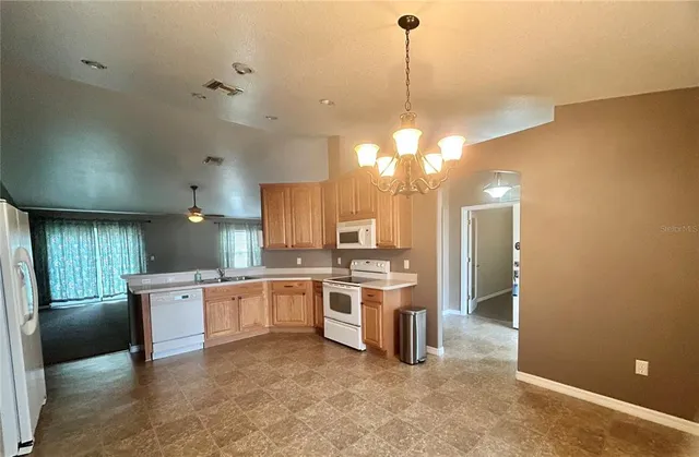 a kitchen with stainless steel appliances a stove a sink and a microwave
