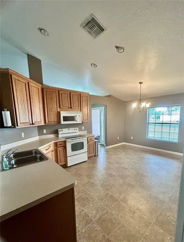 a kitchen with refrigerator and window