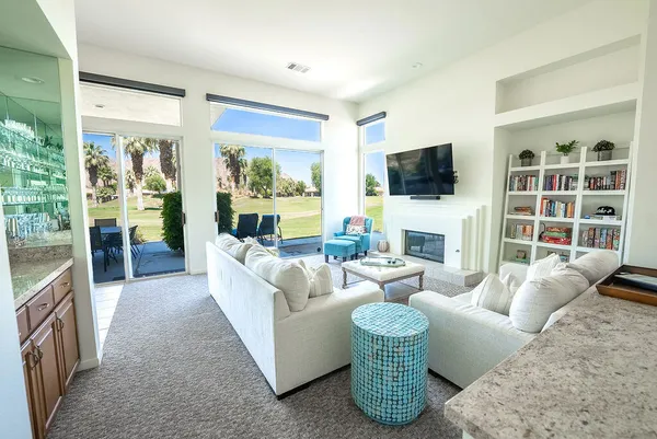 a living room with fireplace furniture and a flat screen tv