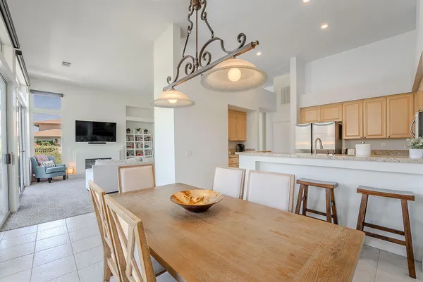 a kitchen that has a table and chairs in it