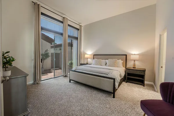 a spacious bedroom with a bed and a cabinets