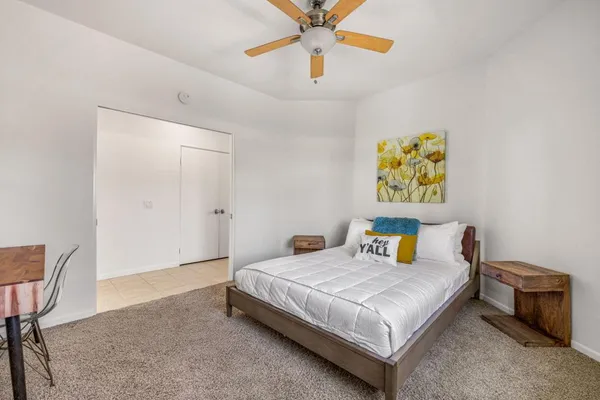 a bedroom with a bed and a table in it