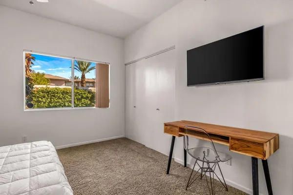 a room with a chair and a flat screen tv