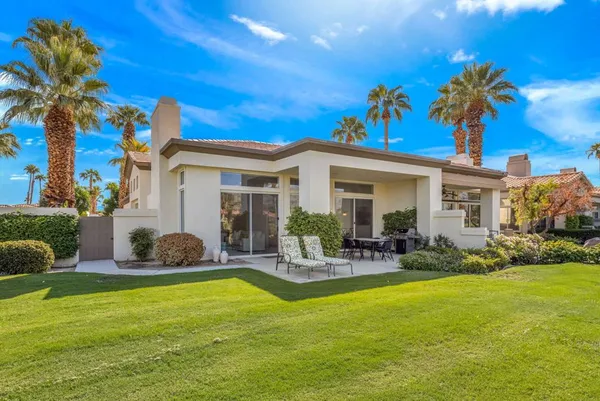 a front view of house with yard and outdoor seating