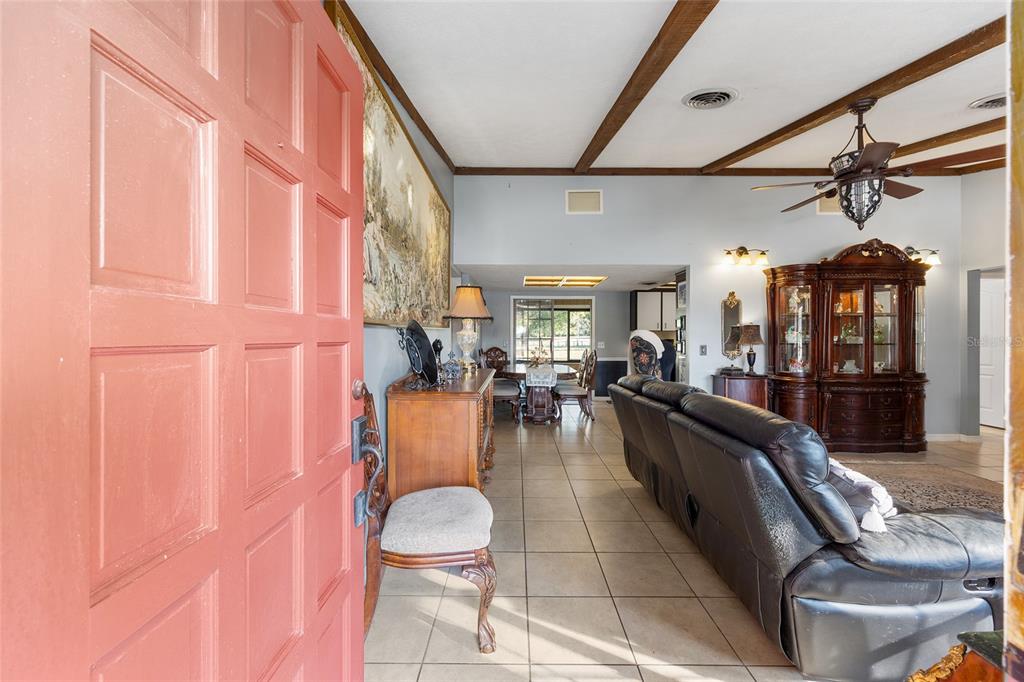 825 Northeast 165th Street Citra, FL 32113 - Photo 11 of 62 a living room with furniture and a chandelier