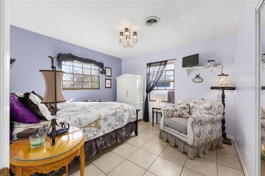825 Northeast 165th Street Citra, FL 32113 - Photo 16 of 62 a bedroom with furniture and a chandelier