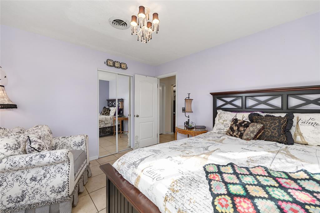 825 Northeast 165th Street Citra, FL 32113 - Photo 17 of 62 a bedroom with a large bed and a dresser