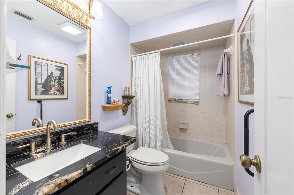 825 Northeast 165th Street Citra, FL 32113 - Photo 18 of 62 a bathroom with a granite countertop sink toilet and shower