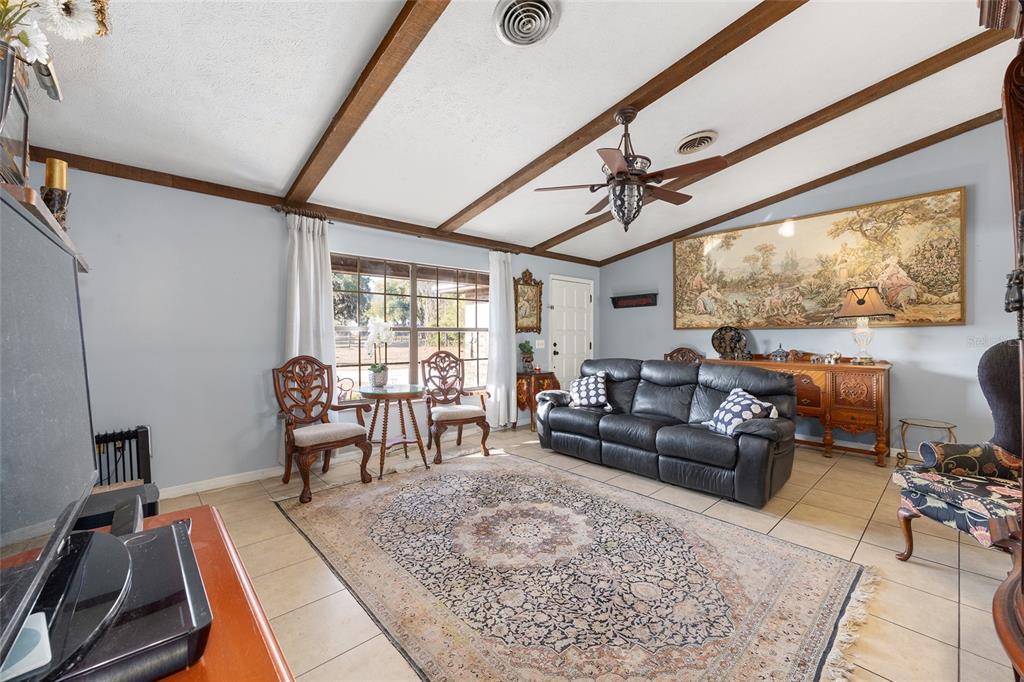 825 Northeast 165th Street Citra, FL 32113 - Photo 19 of 62 a living room with furniture and a window
