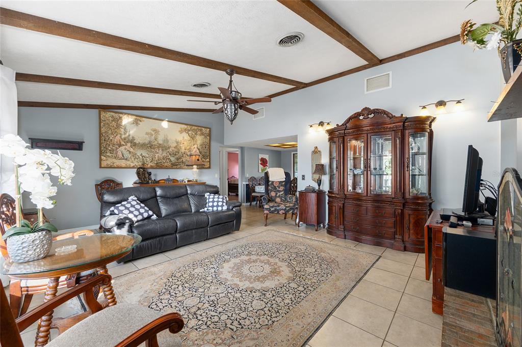 825 Northeast 165th Street Citra, FL 32113 - Photo 20 of 62 a living room with furniture and a flat screen tv