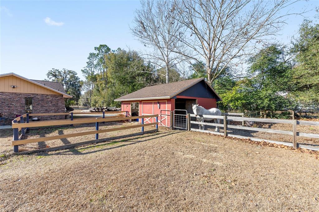 825 Northeast 165th Street Citra, FL 32113 - Photo 2 of 62 a view of house with a yard and large trees