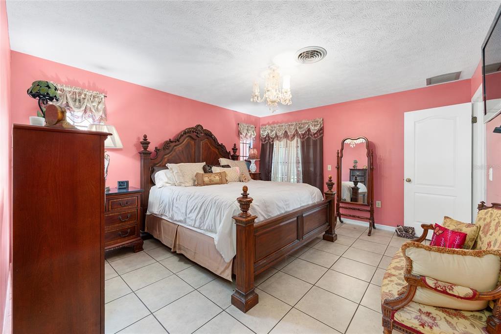 825 Northeast 165th Street Citra, FL 32113 - Photo 25 of 62 a bedroom with a bed and a dresser