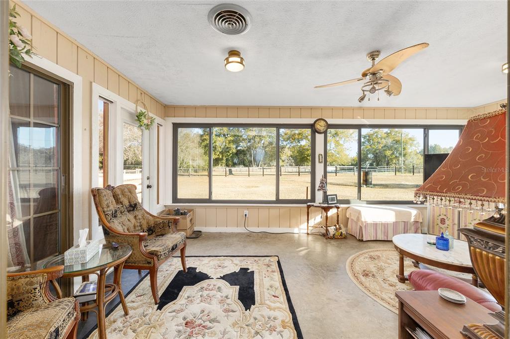 825 Northeast 165th Street Citra, FL 32113 - Photo 27 of 62 a living room with furniture and a large window