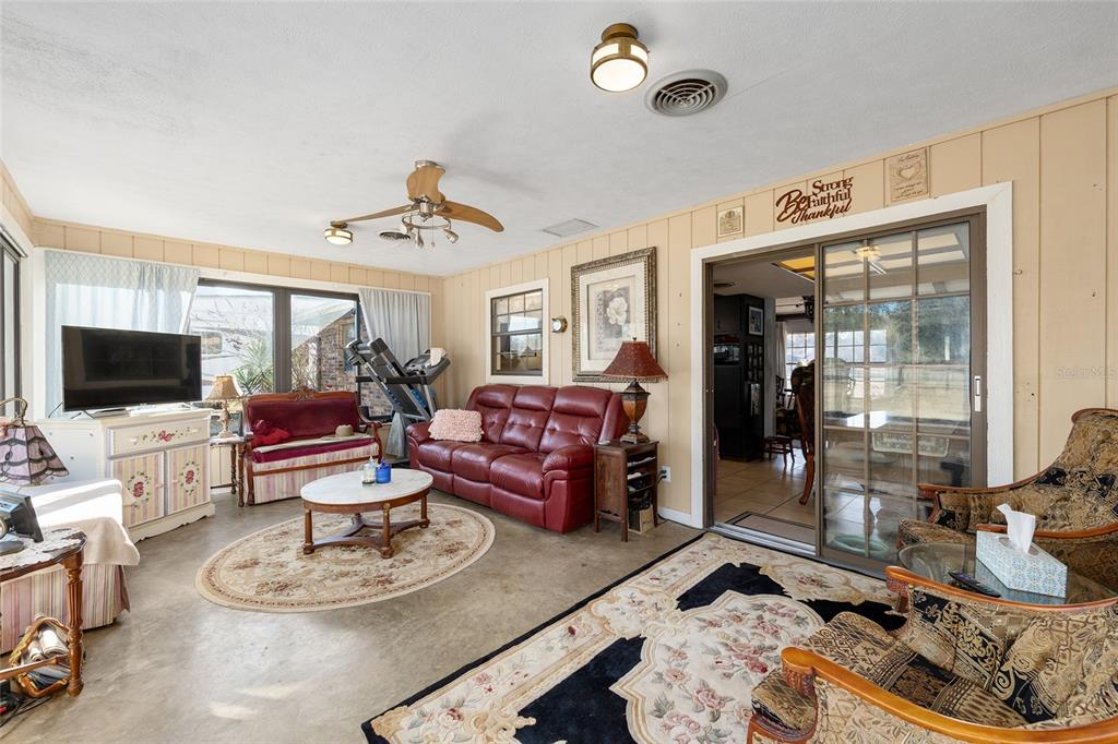 825 Northeast 165th Street Citra, FL 32113 - Photo 28 of 62 a living room with furniture and a flat screen tv