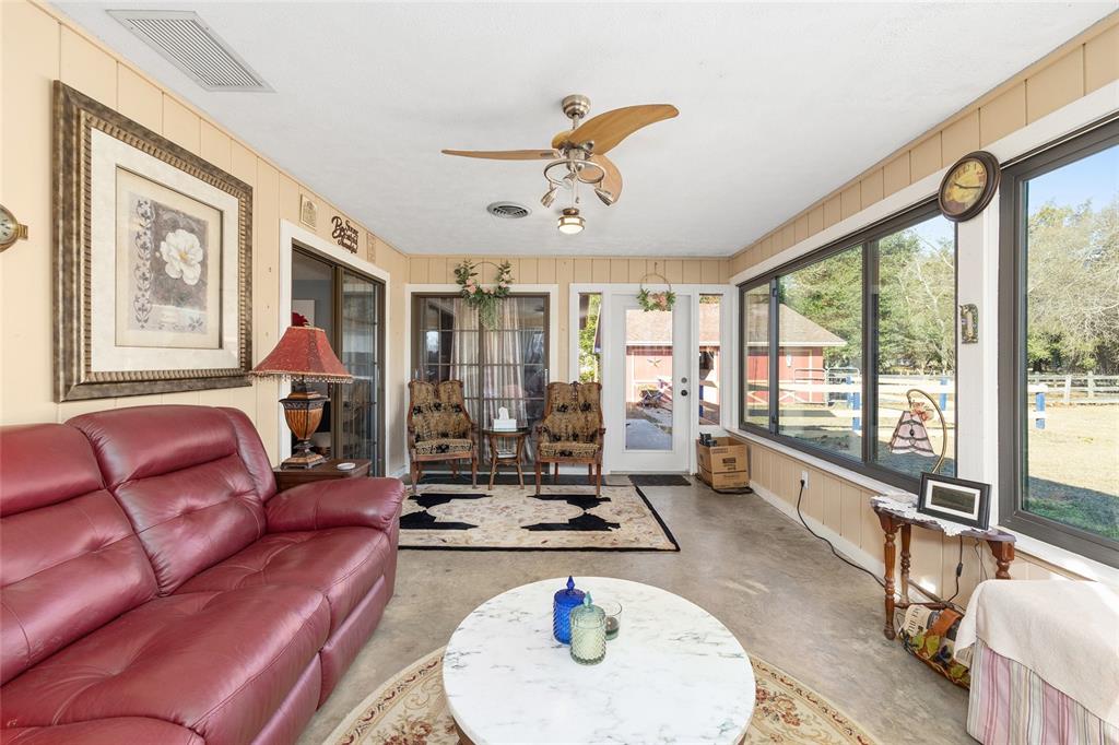 825 Northeast 165th Street Citra, FL 32113 - Photo 30 of 62 a living room with furniture and a large window