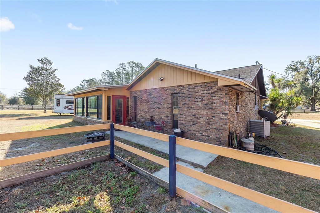 825 Northeast 165th Street Citra, FL 32113 - Photo 38 of 62 a view of house with wooden deck and a yard