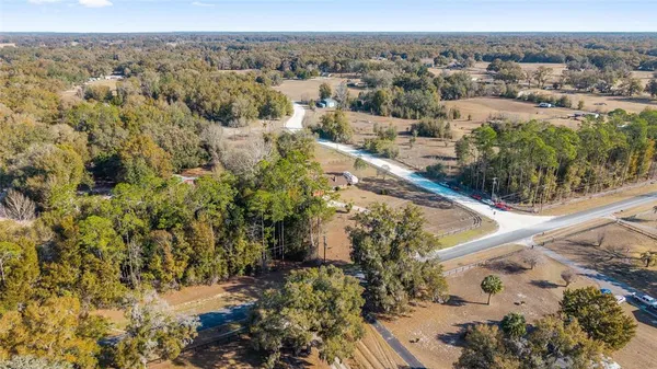 an aerial view of a houses with a yard