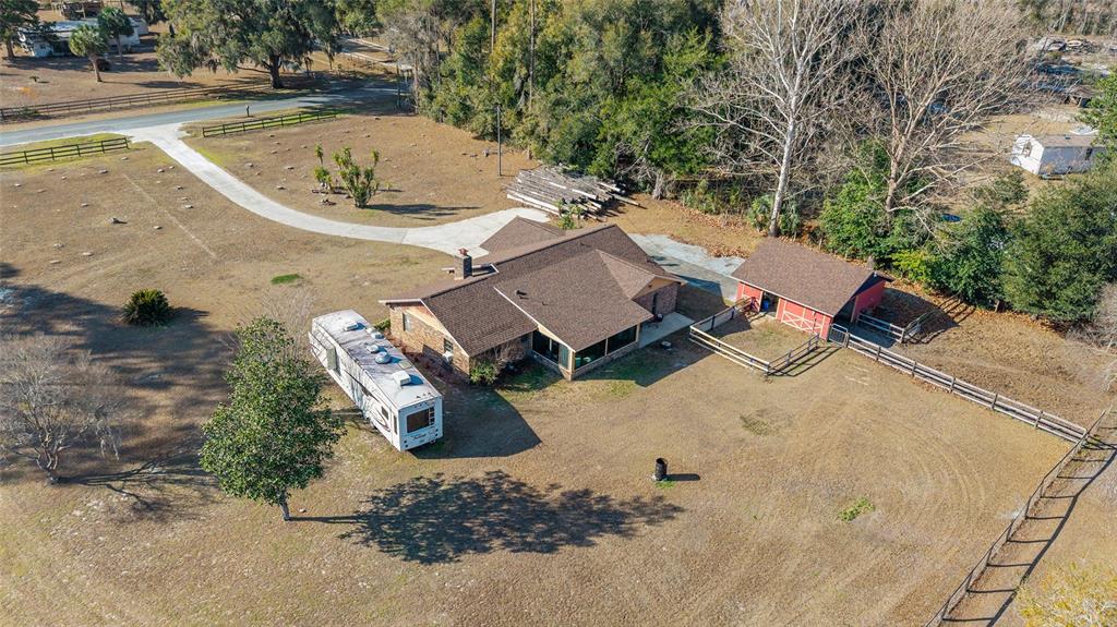 825 Northeast 165th Street Citra, FL 32113 - Photo 56 of 62 an aerial view of a house with a yard and trees