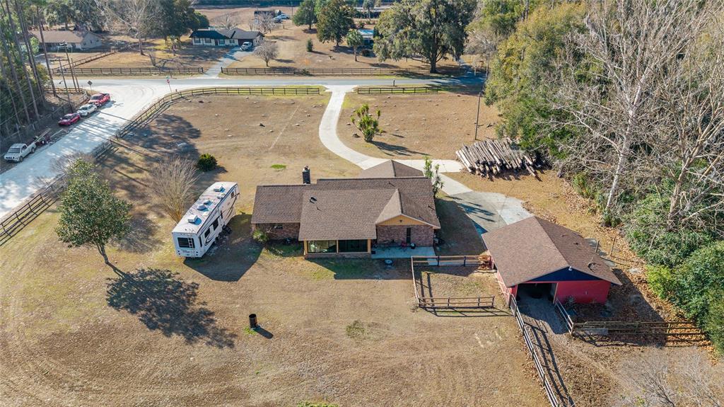 825 Northeast 165th Street Citra, FL 32113 - Photo 57 of 62 an aerial view of a house with swimming pool and porch