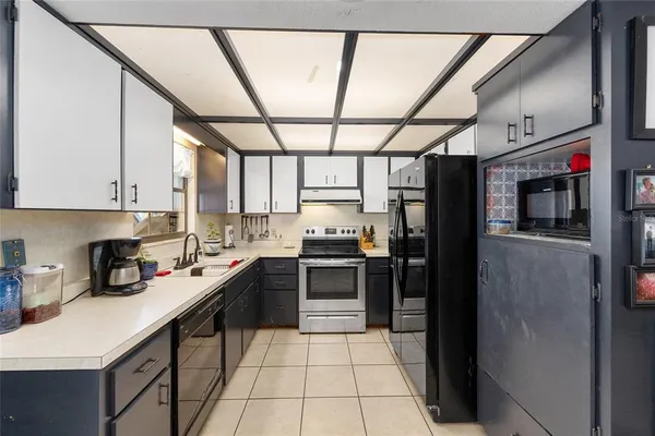 a kitchen with stainless steel appliances granite countertop a stove sink and cabinets