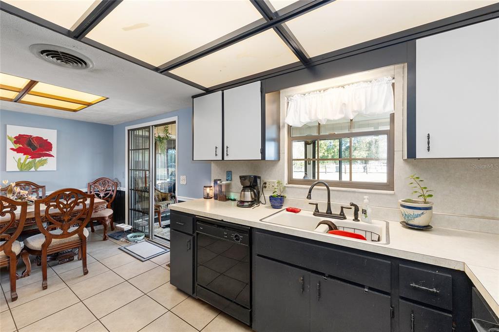 825 Northeast 165th Street Citra, FL 32113 - Photo 10 of 62 a kitchen with a sink cabinets and window