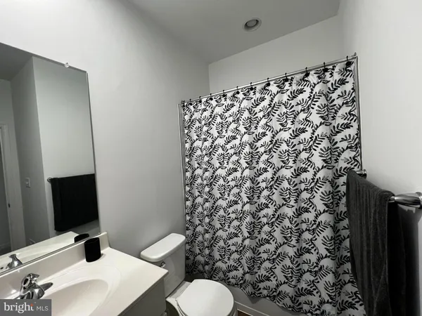 a bathroom with a sink toilet and mirror