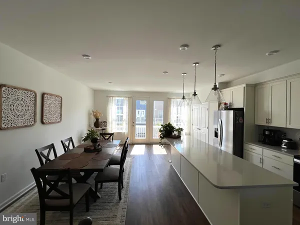 a large kitchen with a table and chairs
